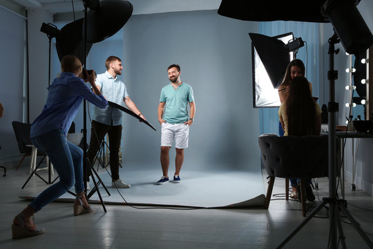 Professional team working with model in photo studio