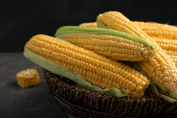 Basket with tasty sweet corn cobs, closeup