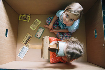 Sisters In A Cardboard Box with A Stereoscope