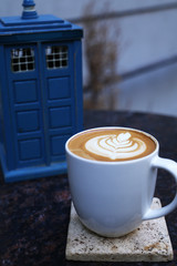 Cafe latte standing on the marble table.