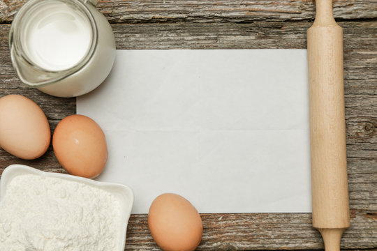 Creating a recipe. Blank paper surrounded by basic ingredients. Add own text.