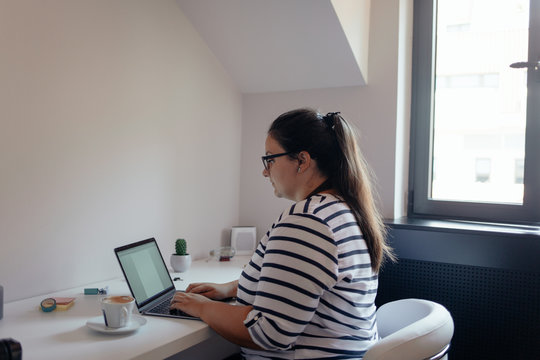 Plus Size Woman Working on a Laptop