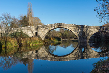 Autumn view of Kadin most - a 15th-century stone arch bridge over the Struma River at Nevestino, Kyustendil Province, Bulgaria