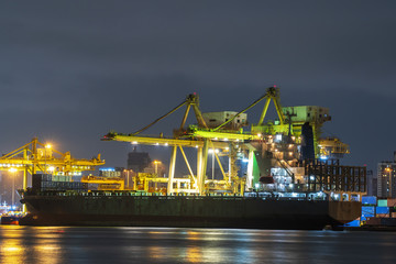 Fototapeta na wymiar Container cargo ship working at night. import export business logistic and transportation