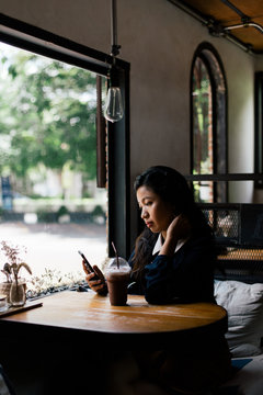 Young Asian woman waiting in the cafe