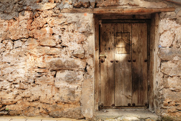 Fototapeta na wymiar Village house with old wooden door
