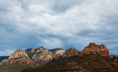 Stunning Sedona, Arizona mountain landscape with dramatic monsoon sky and sun glow