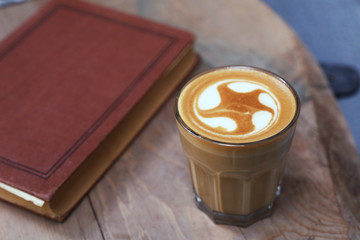 Cafe latte standing on the wood.