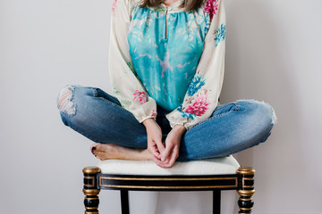 casual, anonymous portrait of a woman sitting in a chair