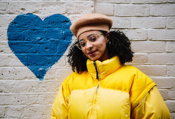 Beautiful mixed ethnicity woman wearing thick yellow puffer jacket