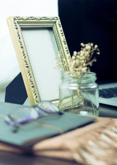 Frame on a table beside a laptop.