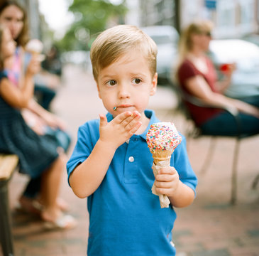 Adorable young boy holding an ice cream