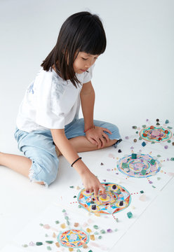 Mandala pattern with crystal and Asian Child