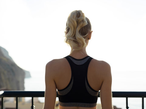 Woman in sportswear at handrail