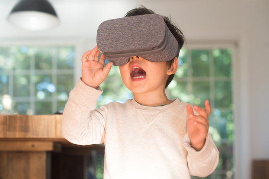 Little kid playing with virtual reality glasses