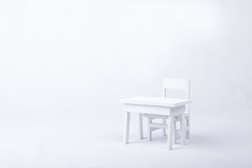 White table and chair on a white background.