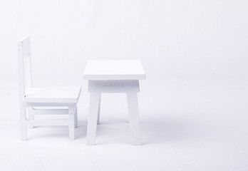White table and chair on a white background.