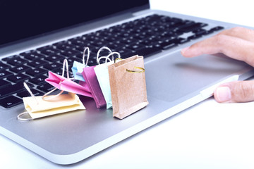 Paper shopping bag on a laptop. Concept of online shopping.