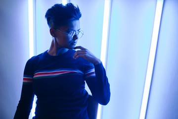 Stylish woman in neon lights