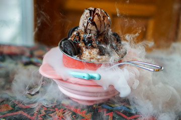 Chocolate Ice Cream on Snowflake ice in colorful bowl, with lava smoke from dry ice.