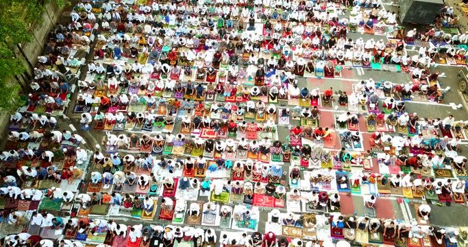 JAKARTA, Indonesia - July 17, 2018: Aerial view of muslim prayer waiting for praying Eid Al Fitr together on the road in Jakarta. Shot in 4k resolution