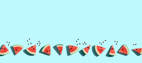 Sliced watermelons arranged on a blue background
