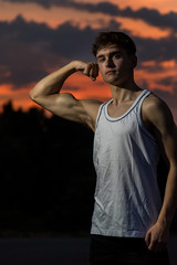 Young adult male outside at sunset