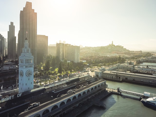 Fototapeta premium Aerial view historic Ferry Building and downtown financial district from Pier 14 waterfront San Francisco, USA