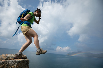 Woman walking off of a cliff edge with the eyes covered