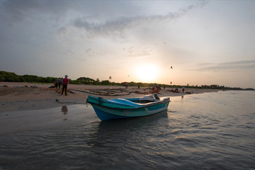 Obraz premium Small fishing boat at twilight sunset on Nilaveli beach in Trincomalee Sri Lanka Asia