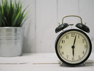 alarm clock on white wooden background