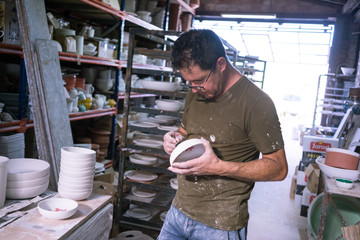 Ceramic dishes in working process. Creating ceramic pieces. Tradicional ceramic factory in spain