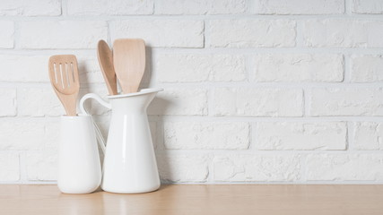 Kitchen utensils and dishware on wooden shelf. Kitchen interior background.Text space.