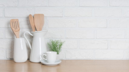 Kitchen utensils and dishware on wooden shelf. Kitchen interior background.Text space.
