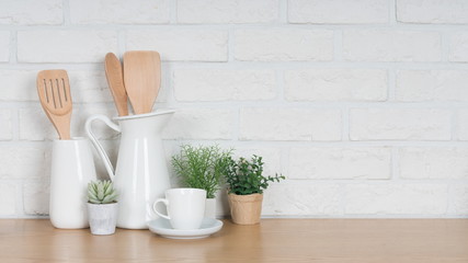 Fototapeta na wymiar Kitchen utensils and dishware on wooden shelf. Kitchen interior background.Text space.