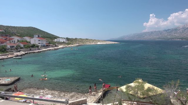Waterfron and beach in Vinjerac, Croatia, pan from left to right
