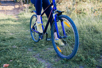 Fototapeta premium Young woman riding a bike