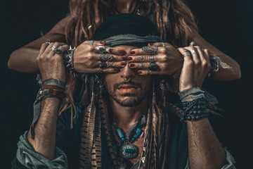 stylish fashionable young handsome man and woman covering his eyes with hands. fashion concept