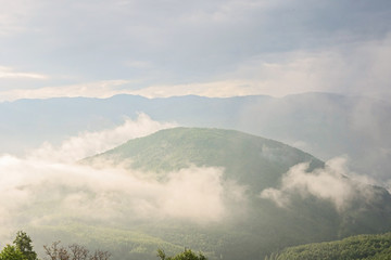 Mountains in magical cloudy sky