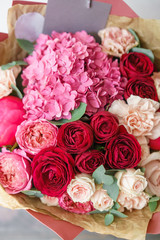 beautiful spring bouquet. flower arrangement with hydrangea and peonies. Color red and pink. The concept of a flower shop, a small family business