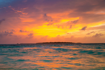 Obraz na płótnie Canvas Sunset on sea in Maldives