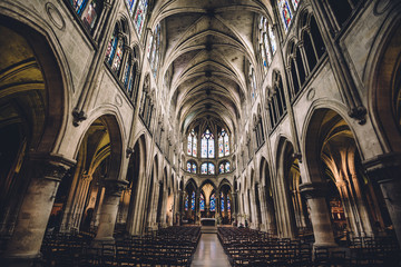 Fototapeta premium Paris, France - August 13, 2017. Inside view of Saint Pierre de Montmartre Church with arches, columns, pews, vault, aisles, gallery, arcades and clerestory. One of the oldest churches in Paris.
