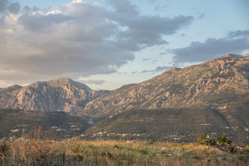 Fototapeta premium Sunset lights over the sea and mountains