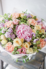 Beautiful spring bouquet. Arrangement with mix flowers. The concept of a flower shop, a small family business. Color light pink and lilac.