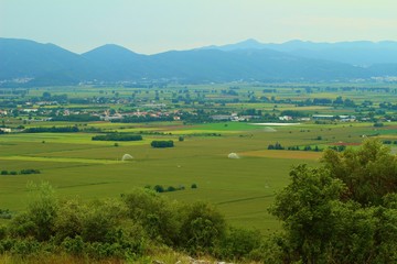 A photo of mountains and the fields beneath in greece