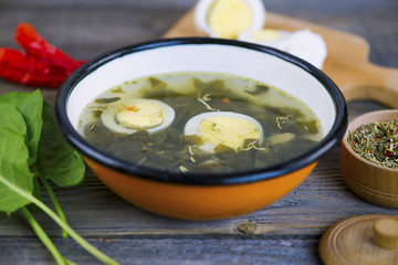 green sorrel soup with egg and spices