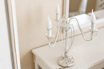 interior hotel apartment, comfortable room, mirror and desk. Lamp standing on a table in a hotel room