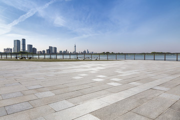 Panoramic skyline and modern business office buildings with empty road,empty concrete square floor