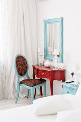 interior hotel apartment, comfortable room, mirror and desk. folder for notes and lamp standing on a table in a hotel room