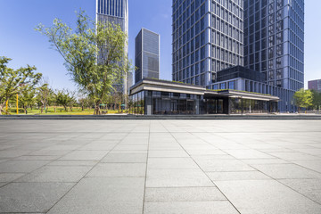 Fototapeta premium Panoramic skyline and modern business office buildings with empty road,empty concrete square floor